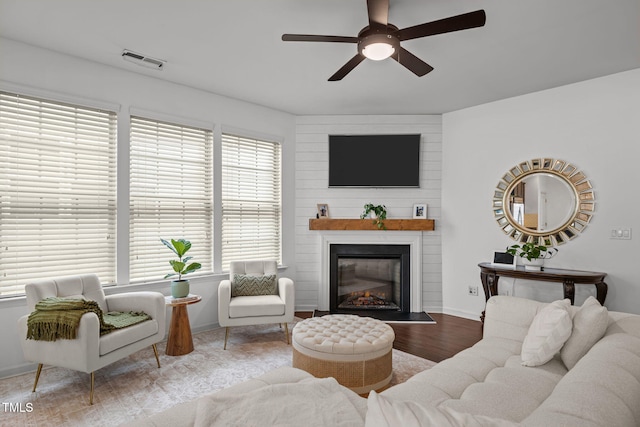 2700 Benevolence Dr, Raleigh, NC 27610 - living area with ceiling fan, wood finished floors, and a large fireplace