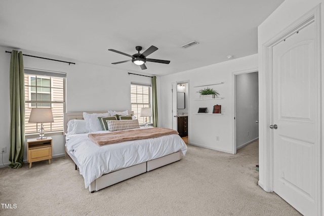 2700 Benevolence Dr, Raleigh, NC 27610 - bedroom with light colored carpet, multiple windows, ceiling fan, and ensuite bathroom