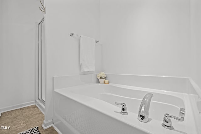 2700 Benevolence Dr, Raleigh, NC 27610 - bathroom featuring a bath, a shower stall, and tile patterned flooring