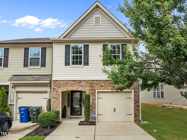 2700 Benevolence Dr, Raleigh, NC 27610 - view of front of house featuring a garage, concrete driveway, stone siding, and a front yard
