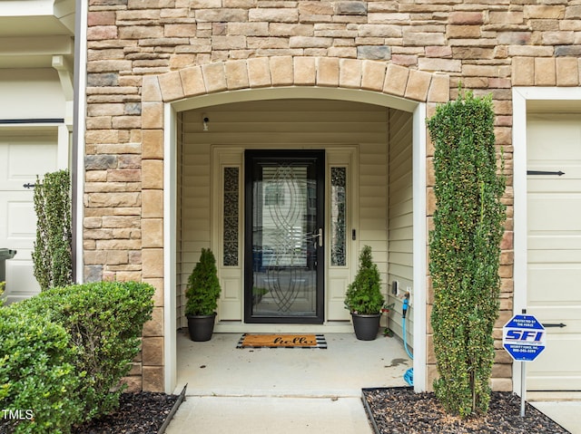 2700 Benevolence Dr, Raleigh, NC 27610 - doorway to property featuring a garage and stone siding