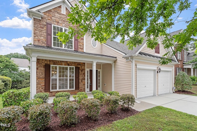 212 Oswego Ct, Morrisville, NC 27560 - traditional-style home with stone siding, driveway, a porch, an attached garage, and roof with shingles