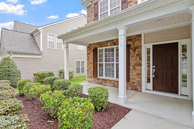 212 Oswego Ct, Morrisville, NC 27560 - view of exterior entry featuring stone siding and a porch