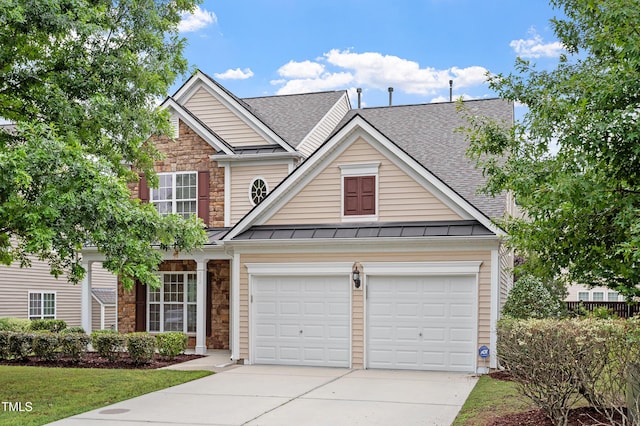 212 Oswego Ct, Morrisville, NC 27560 - traditional-style home with a standing seam roof, stone siding, driveway, and a shingled roof