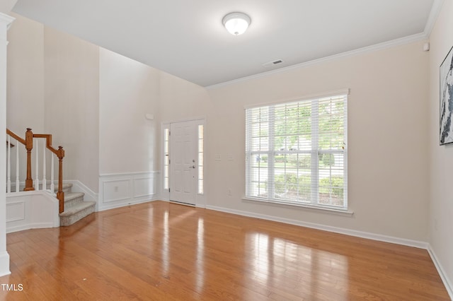 212 Oswego Ct, Morrisville, NC 27560 - entrance foyer with wood finished floors, stairway, ornamental molding, and wainscoting