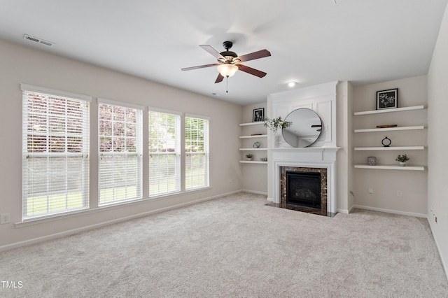 212 Oswego Ct, Morrisville, NC 27560 - unfurnished living room with ceiling fan, a fireplace, carpet floors, and built in shelves