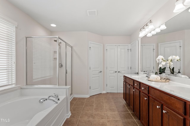 212 Oswego Ct, Morrisville, NC 27560 - bathroom featuring a closet, a stall shower, double vanity, a bath, and healthy amount of natural light