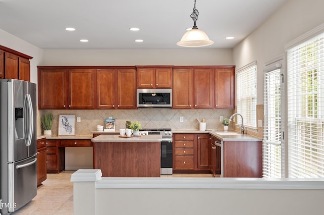 212 Oswego Ct, Morrisville, NC 27560 - kitchen featuring stainless steel appliances, light countertops, tasteful backsplash, a kitchen island, and recessed lighting