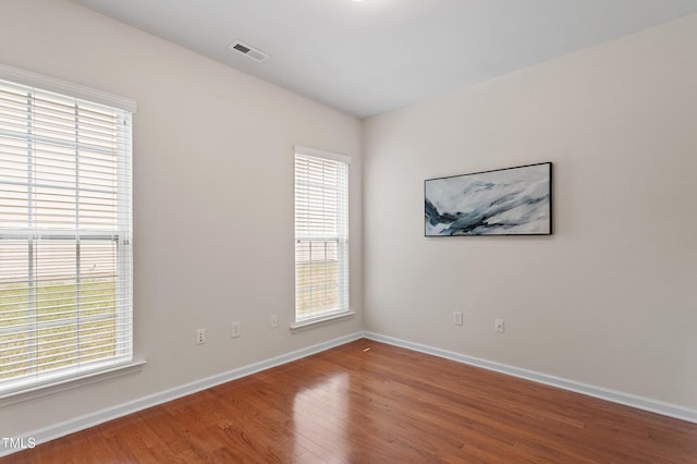 212 Oswego Ct, Morrisville, NC 27560 - empty room with plenty of natural light and wood finished floors