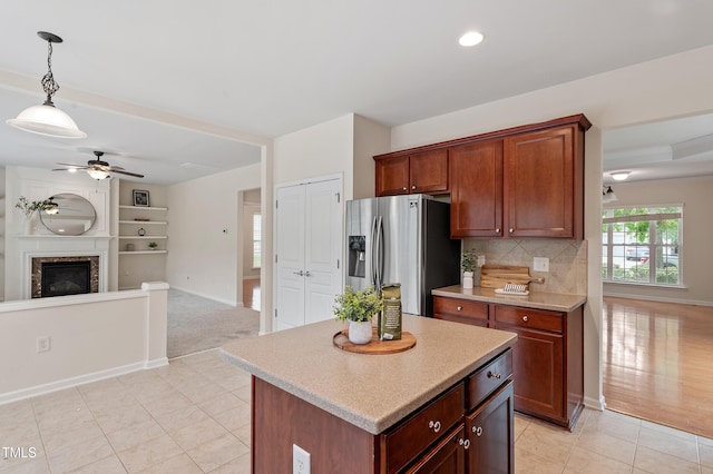 212 Oswego Ct, Morrisville, NC 27560 - kitchen featuring stainless steel fridge with ice dispenser, ceiling fan, open floor plan, light countertops, and hanging light fixtures