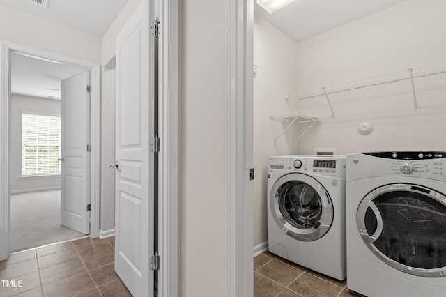 212 Oswego Ct, Morrisville, NC 27560 - laundry area with washing machine and clothes dryer and tile patterned floors