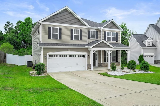 45 Commodore Ct, Cameron, NC 28326 - craftsman-style house featuring a porch, an attached garage, concrete driveway, and stone siding