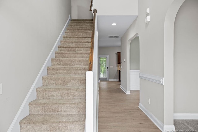 45 Commodore Ct, Cameron, NC 28326 - stairs featuring arched walkways, wood finished floors, and recessed lighting