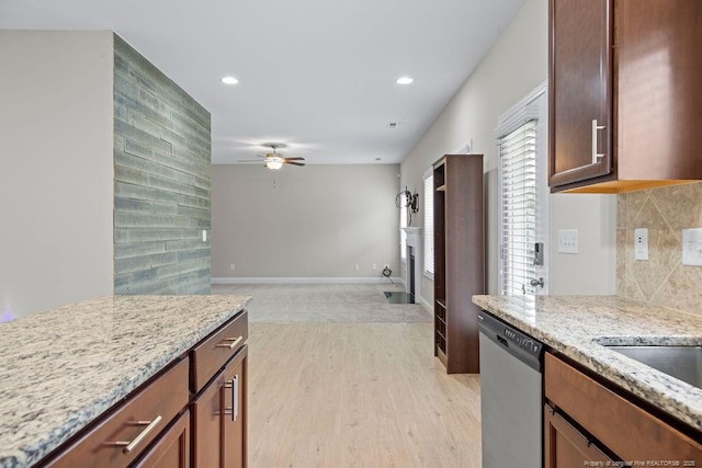 45 Commodore Ct, Cameron, NC 28326 - kitchen featuring dishwasher, ceiling fan, light stone countertops, a fireplace, and decorative backsplash