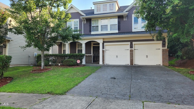 523 Front Ridge Dr, Cary, NC 27519 - craftsman-style home featuring an attached garage, concrete driveway, a front yard, a porch, and brick siding