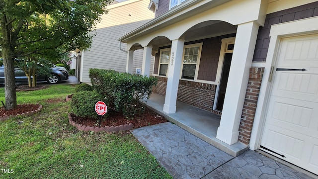523 Front Ridge Dr, Cary, NC 27519 - entrance to property with brick siding, covered porch, and a garage