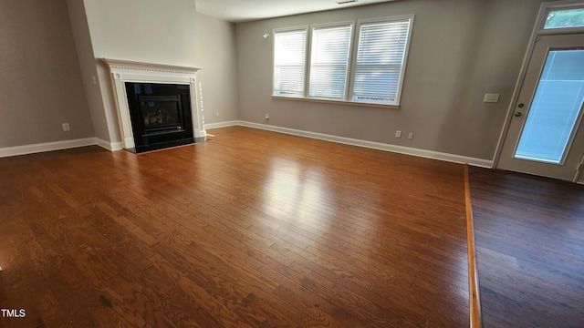 523 Front Ridge Dr, Cary, NC 27519 - unfurnished living room with wood-type flooring and a fireplace with flush hearth