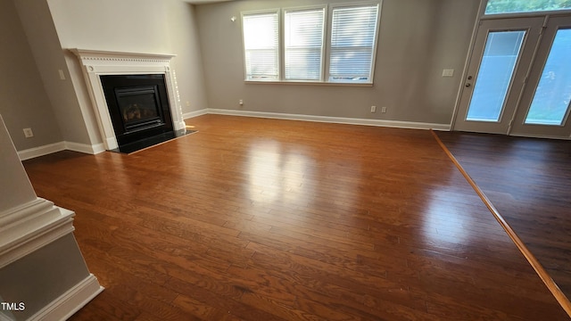 523 Front Ridge Dr, Cary, NC 27519 - unfurnished living room with plenty of natural light, dark wood-type flooring, and a fireplace with flush hearth