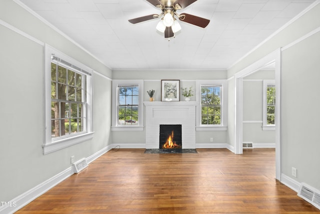 113 Herbert St, Durham, NC 27703 - unfurnished living room featuring healthy amount of natural light, a brick fireplace, wood finished floors, and crown molding