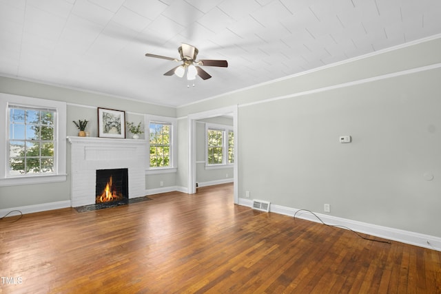 113 Herbert St, Durham, NC 27703 - unfurnished living room with a ceiling fan, a brick fireplace, wood-type flooring, and ornamental molding