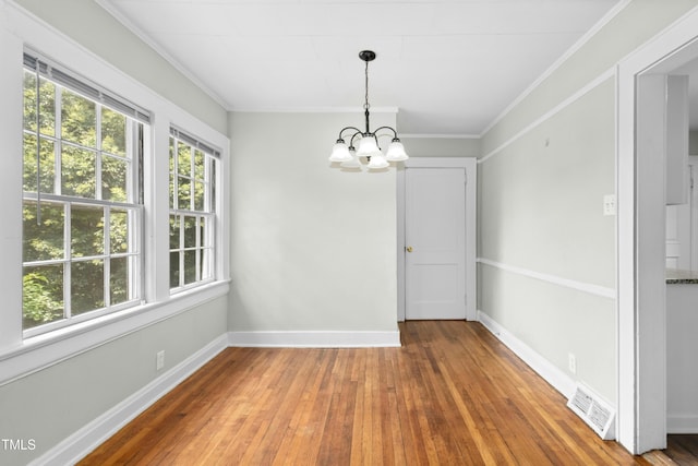 113 Herbert St, Durham, NC 27703 - unfurnished dining area with a chandelier, wood-type flooring, and crown molding