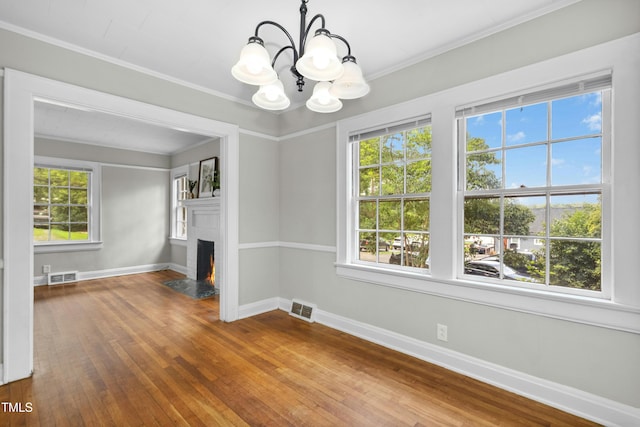 113 Herbert St, Durham, NC 27703 - unfurnished dining area featuring a chandelier, hardwood / wood-style flooring, a fireplace with flush hearth, and ornamental molding