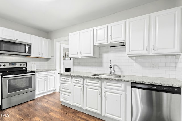 113 Herbert St, Durham, NC 27703 - kitchen with appliances with stainless steel finishes, white cabinetry, decorative backsplash, and dark wood-type flooring