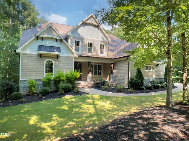 3575 Bragg Valley Ln, Wake Forest, NC 27587 - craftsman-style home featuring a front lawn, covered porch, and stone siding