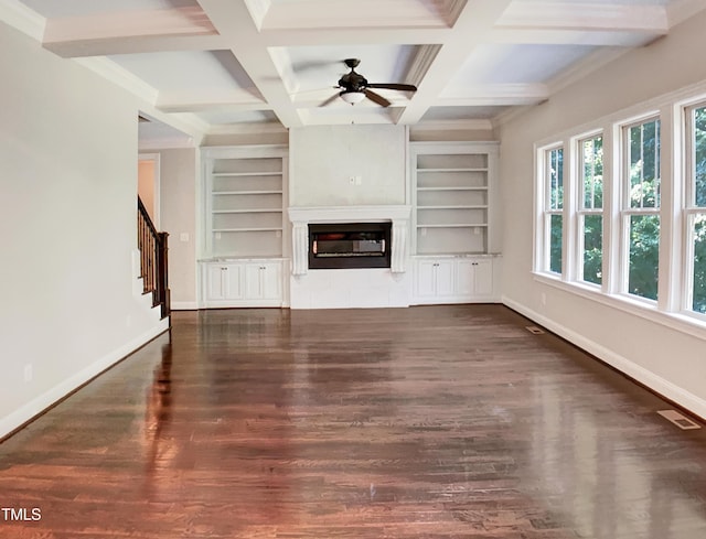 3575 Bragg Valley Ln, Wake Forest, NC 27587 - unfurnished living room featuring built in shelves, ceiling fan, wood finished floors, a glass covered fireplace, and beam ceiling