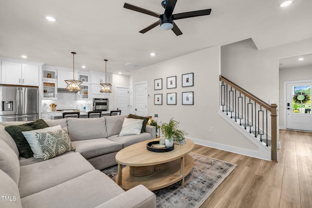 403 Sustainable Way, Raleigh, NC 27610 - living room featuring recessed lighting, a ceiling fan, light wood-type flooring, and stairway