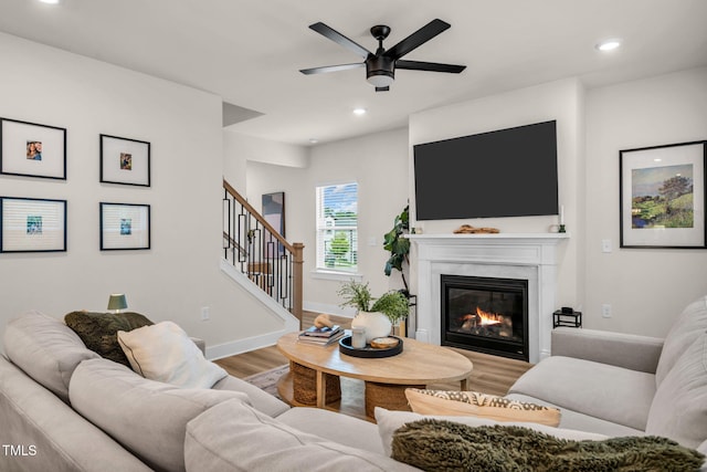403 Sustainable Way, Raleigh, NC 27610 - living area with wood finished floors, a ceiling fan, a glass covered fireplace, recessed lighting, and stairs