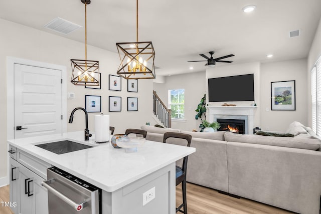 403 Sustainable Way, Raleigh, NC 27610 - kitchen featuring dishwasher, a kitchen bar, light wood finished floors, open floor plan, and recessed lighting