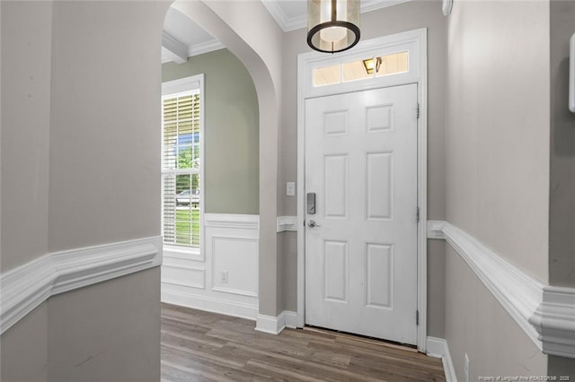 4041 Lifestyle Rd, Fayetteville, NC 28312 - entryway featuring arched walkways, ornamental molding, wood finished floors, and wainscoting