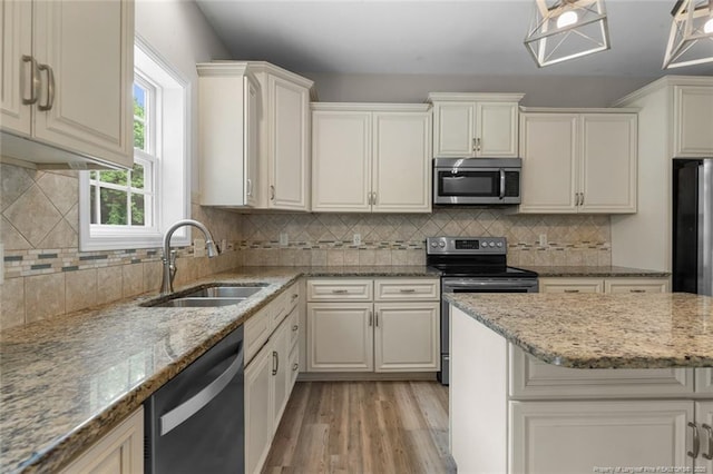 4041 Lifestyle Rd, Fayetteville, NC 28312 - kitchen with appliances with stainless steel finishes, light wood-style floors, light stone countertops, and decorative backsplash