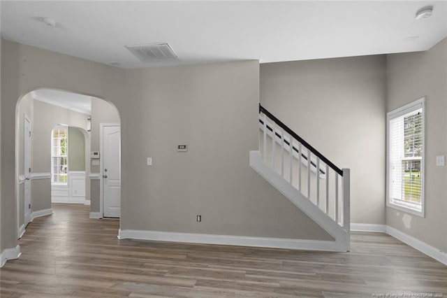 4041 Lifestyle Rd, Fayetteville, NC 28312 - interior space with wood finished floors, arched walkways, and stairs