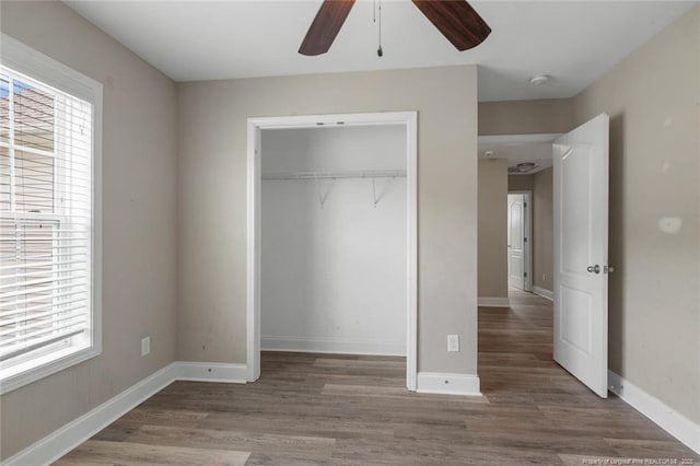 4041 Lifestyle Rd, Fayetteville, NC 28312 - unfurnished bedroom featuring a closet, wood finished floors, and ceiling fan