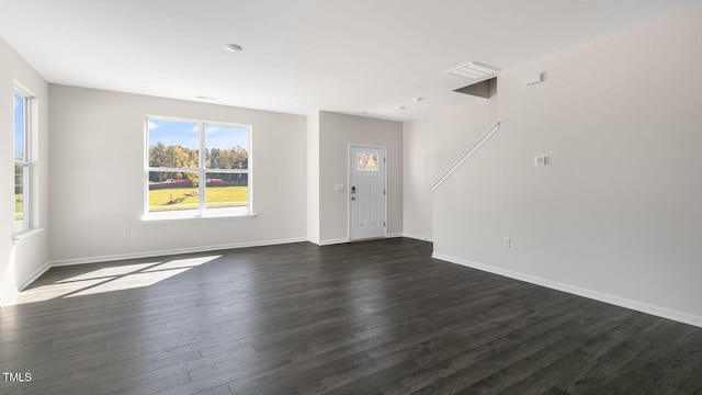 824 Old Tarboro Rd, Wendell, NC 27591 - unfurnished living room with dark wood-style flooring and baseboards