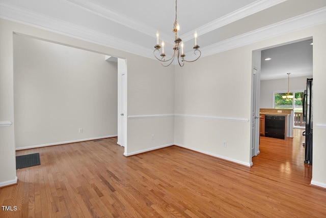 4518 Coral Dr, Durham, NC 27713 - spare room with a chandelier, light wood-type flooring, and crown molding