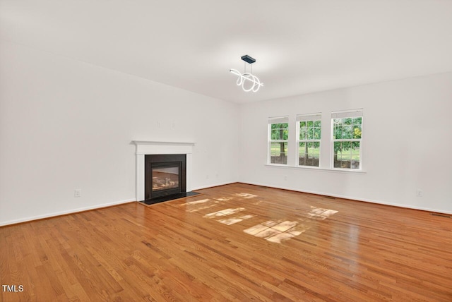 4518 Coral Dr, Durham, NC 27713 - unfurnished living room with wood finished floors and a fireplace with flush hearth