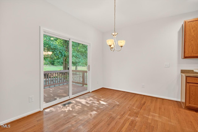 4518 Coral Dr, Durham, NC 27713 - unfurnished dining area with light wood-style floors and a chandelier