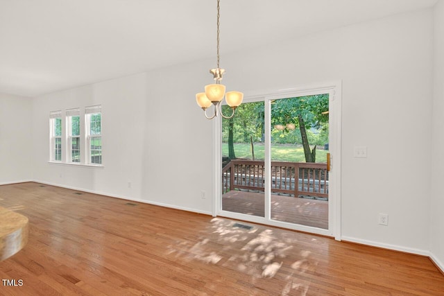 4518 Coral Dr, Durham, NC 27713 - unfurnished room with wood finished floors and a chandelier