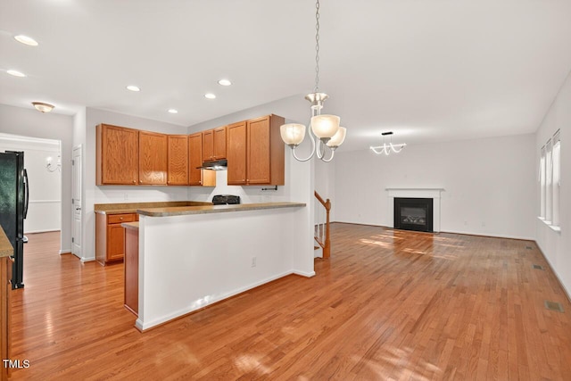 4518 Coral Dr, Durham, NC 27713 - kitchen featuring light wood finished floors, under cabinet range hood, a chandelier, recessed lighting, and freestanding refrigerator
