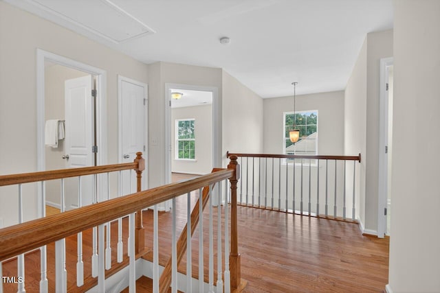 4518 Coral Dr, Durham, NC 27713 - hall featuring an upstairs landing, attic access, wood finished floors, and plenty of natural light