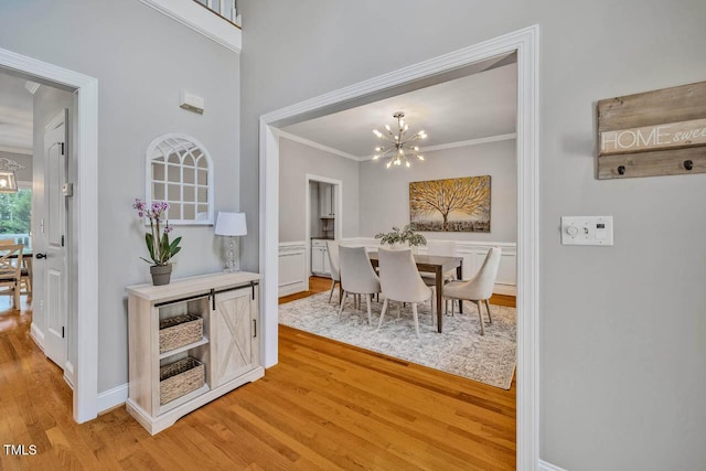 7269 Bedford Ridge Dr, Apex, NC 27539 - dining room with a chandelier, light wood-style floors, and ornamental molding
