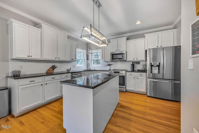7269 Bedford Ridge Dr, Apex, NC 27539 - kitchen featuring appliances with stainless steel finishes, crown molding, white cabinets, recessed lighting, and light wood-type flooring