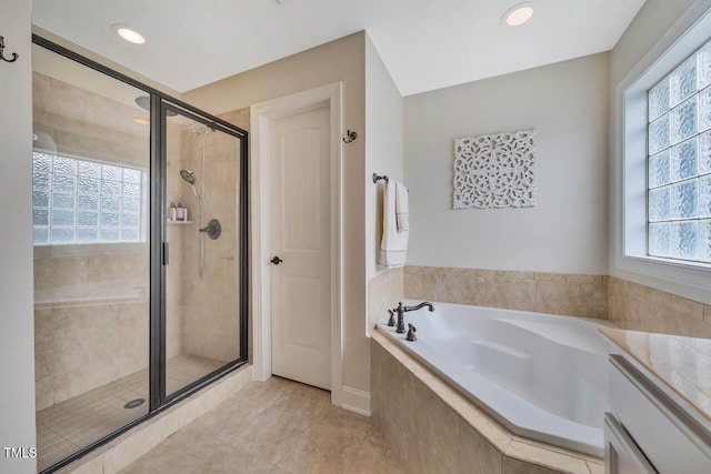 7269 Bedford Ridge Dr, Apex, NC 27539 - bathroom featuring a bath, healthy amount of natural light, a stall shower, tile patterned floors, and recessed lighting