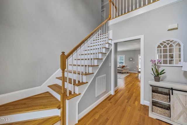 7269 Bedford Ridge Dr, Apex, NC 27539 - staircase featuring wood finished floors and a high ceiling