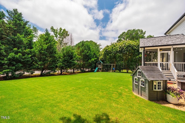 7269 Bedford Ridge Dr, Apex, NC 27539 - view of green lawn featuring a sunroom, a playground, and an outbuilding