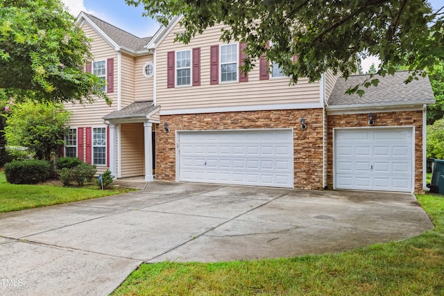 2228 Cedar Grove Dr, Durham, NC 27703 - traditional-style home featuring driveway, stone siding, an attached garage, and a shingled roof
