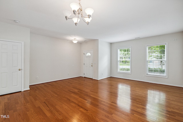 2228 Cedar Grove Dr, Durham, NC 27703 - unfurnished living room with a chandelier and wood finished floors